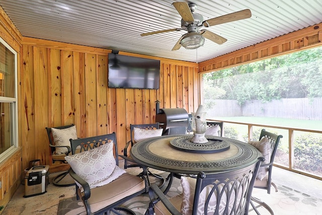 sunroom / solarium with ceiling fan and outdoor dining space