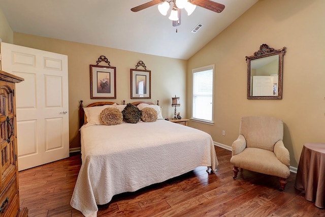 bedroom with vaulted ceiling, wood finished floors, baseboards, and ceiling fan