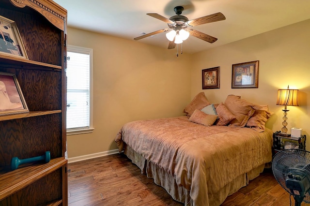 bedroom with wood finished floors, baseboards, and ceiling fan