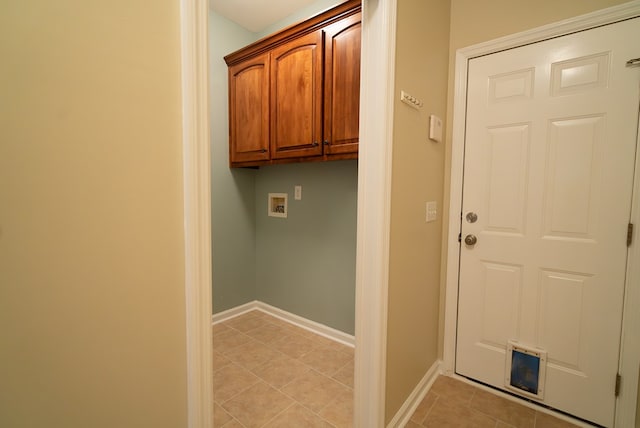 clothes washing area featuring light tile patterned flooring, cabinets, and hookup for a washing machine