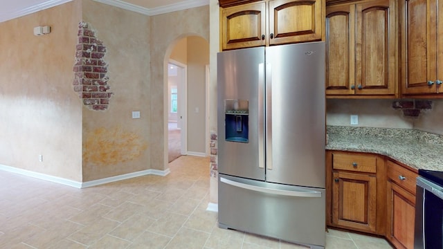 kitchen with light stone countertops, stainless steel appliances, and ornamental molding