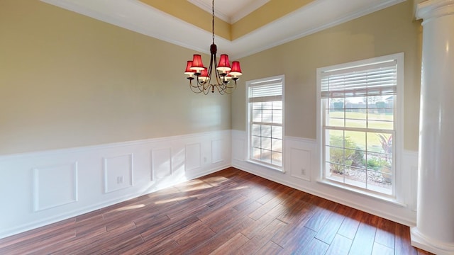 unfurnished dining area with a notable chandelier, dark hardwood / wood-style flooring, and crown molding