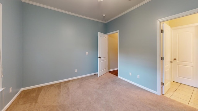 unfurnished bedroom with light colored carpet and ornamental molding