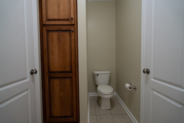 bathroom featuring toilet and tile patterned floors