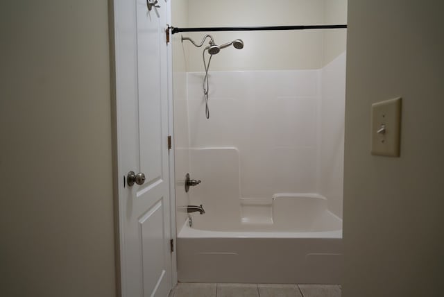 bathroom featuring tile patterned flooring and shower / bathtub combination