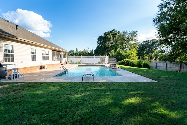 view of swimming pool featuring a patio area and a yard