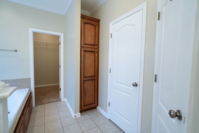 bathroom featuring tile patterned floors, a bath, and crown molding