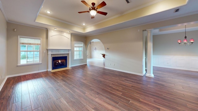 unfurnished living room featuring plenty of natural light, dark hardwood / wood-style floors, and crown molding