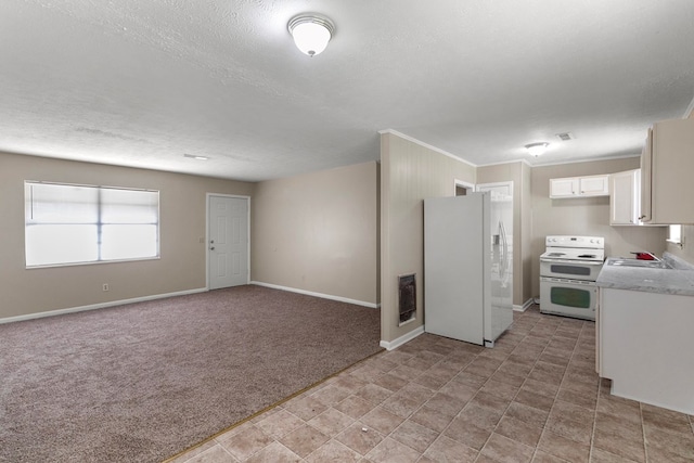 kitchen with sink, white cabinetry, light carpet, a textured ceiling, and white appliances