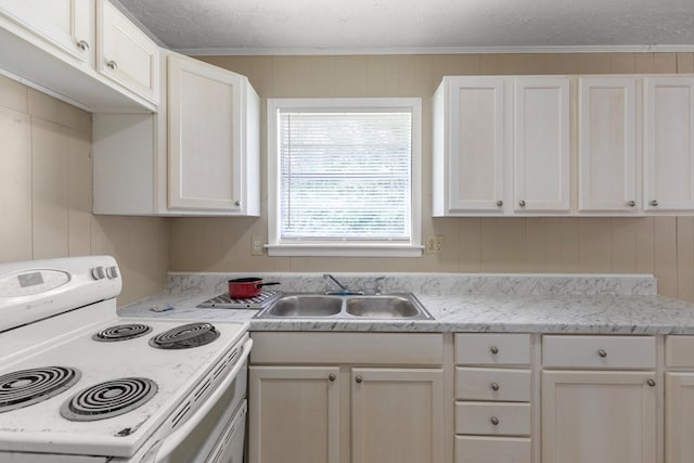 kitchen with white electric stove, sink, white cabinets, and a textured ceiling