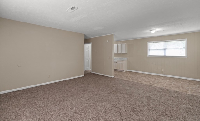 unfurnished room featuring light carpet and a textured ceiling