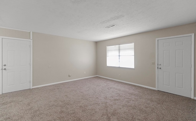 unfurnished room featuring carpet floors and a textured ceiling