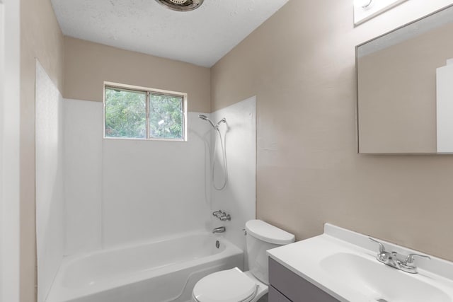 full bathroom featuring vanity, toilet, a textured ceiling, and shower / bathing tub combination