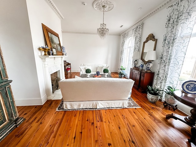 2023 J Saunders Rd, Dothan, AL 36305 - living area featuring wood finished floors, a chandelier, a fireplace, and baseboards