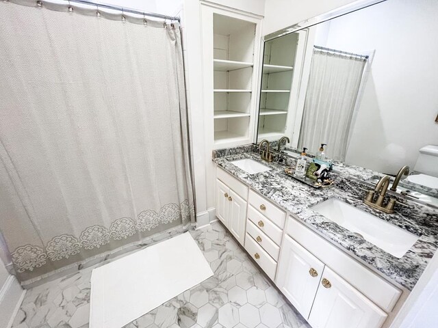 2023 J Saunders Rd, Dothan, AL 36305 - full bathroom featuring marble finish floors, double vanity, toilet, and curtained shower
