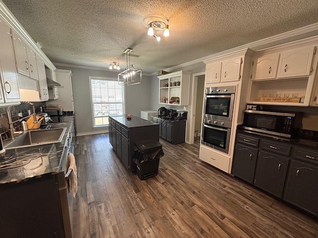 112 Vixen Ct, Dothan, AL 36305 - kitchen with stainless steel appliances, open shelves, ornamental molding, dark countertops, and dark wood-style flooring