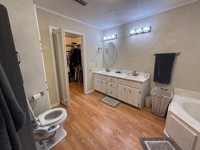 112 Vixen Ct, Dothan, AL 36305 - full bathroom featuring crown molding, wood finished floors, a textured ceiling, double vanity, and a textured wall