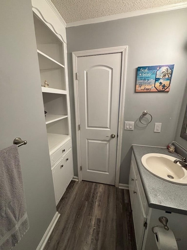 112 Vixen Ct, Dothan, AL 36305 - bathroom with a textured ceiling, wood finished floors, crown molding, and vanity