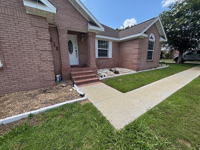 112 Vixen Ct, Dothan, AL 36305 - view of exterior entry featuring brick siding and a yard