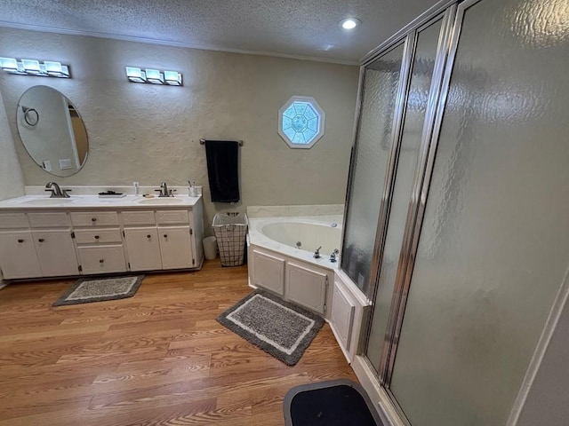 112 Vixen Ct, Dothan, AL 36305 - bathroom featuring a textured wall, wood finished floors, a shower stall, a textured ceiling, and a whirlpool tub