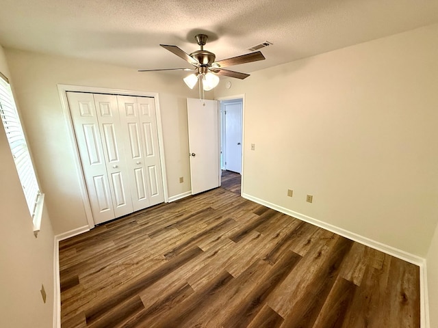 2419 Creekwood Dr, Dothan, AL 36301 - unfurnished bedroom with dark wood-type flooring, a closet, ceiling fan, and a textured ceiling