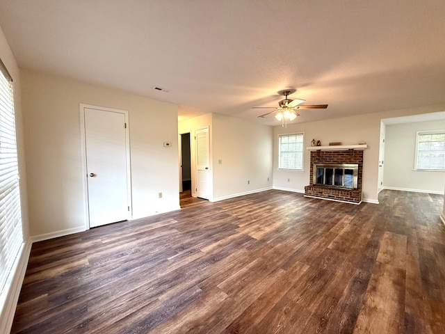 2419 Creekwood Dr, Dothan, AL 36301 - unfurnished living room featuring dark wood finished floors, ceiling fan, and a brick fireplace
