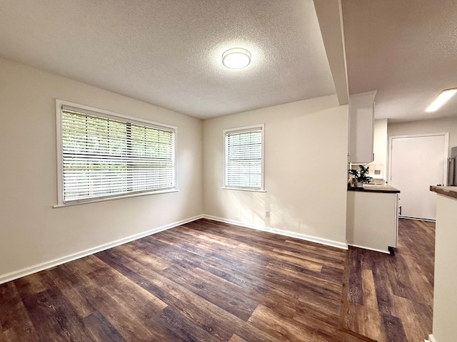 2419 Creekwood Dr, Dothan, AL 36301 - unfurnished room with a textured ceiling and dark wood-style flooring