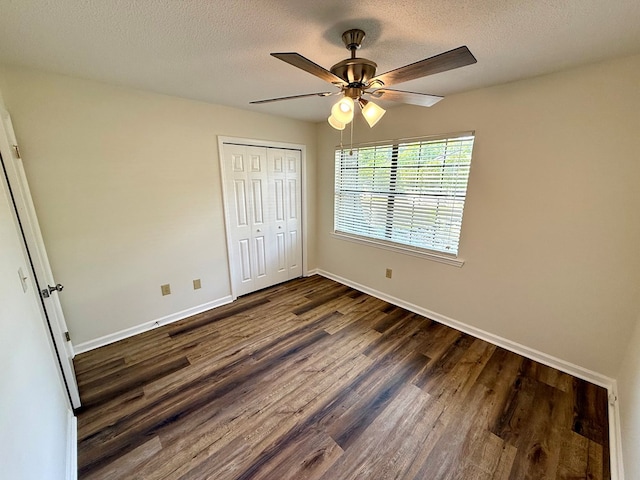 2419 Creekwood Dr, Dothan, AL 36301 - unfurnished bedroom featuring dark wood-style floors, a closet, a ceiling fan, and a textured ceiling