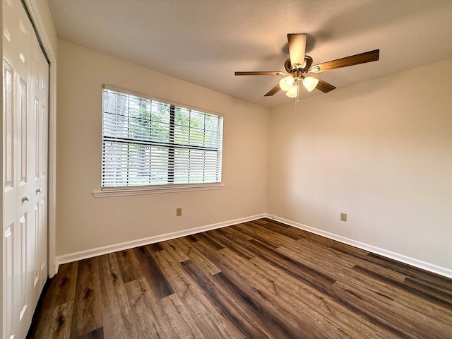 2419 Creekwood Dr, Dothan, AL 36301 - unfurnished bedroom with a closet, dark wood-type flooring, and a ceiling fan