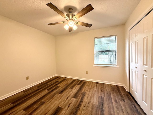 2419 Creekwood Dr, Dothan, AL 36301 - unfurnished bedroom featuring dark wood-style floors, a closet, a textured ceiling, and a ceiling fan