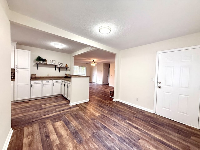 2419 Creekwood Dr, Dothan, AL 36301 - kitchen featuring dark countertops, open shelves, dark wood finished floors, a peninsula, and open floor plan