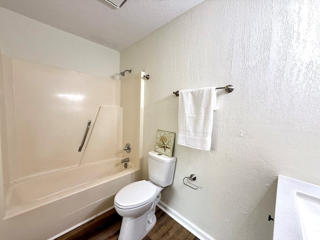 2419 Creekwood Dr, Dothan, AL 36301 - full bathroom with wood finished floors,  shower combination, and a textured ceiling