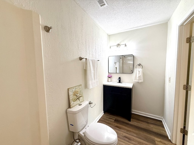 2419 Creekwood Dr, Dothan, AL 36301 - bathroom featuring a textured ceiling, vanity, wood finished floors, and a textured wall