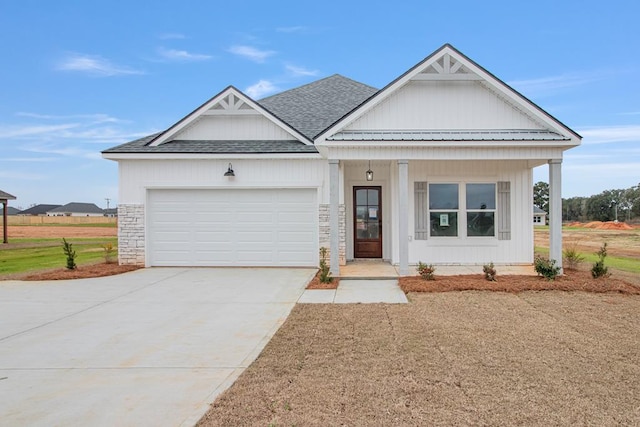 view of front of property featuring a garage and covered porch