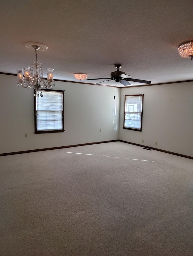 empty room with ceiling fan with notable chandelier, carpet floors, and a textured ceiling