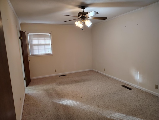 carpeted spare room featuring ceiling fan and ornamental molding