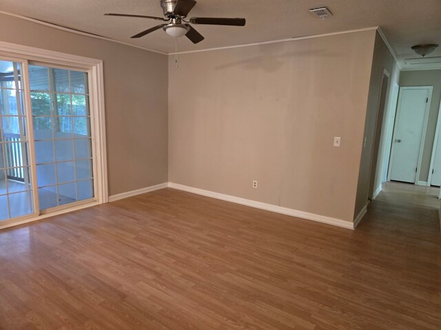 100 Pridmore St, Daleville, AL 36322 - empty room with wood finished floors, ceiling fan, baseboards, and crown molding