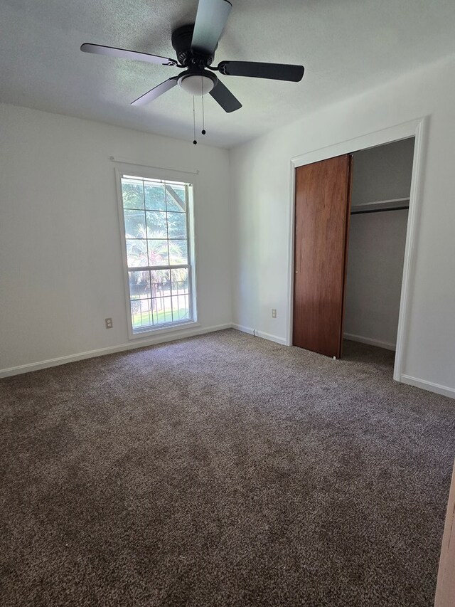 100 Pridmore St, Daleville, AL 36322 - unfurnished bedroom featuring a closet, baseboards, carpet floors, and a textured ceiling