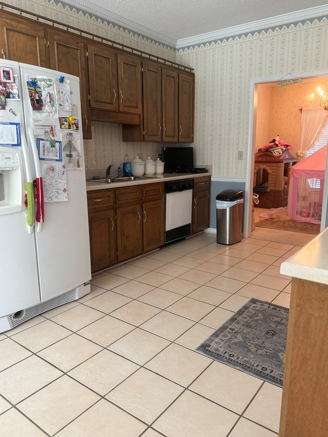 104 Wellston Ct, Dothan, AL 36305 - kitchen with white appliances, wallpapered walls, light countertops, a textured ceiling, and dark brown cabinets
