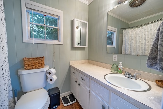 bathroom with vanity, crown molding, hardwood / wood-style flooring, toilet, and walk in shower