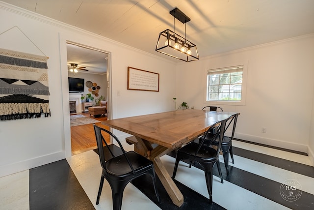 dining area featuring ceiling fan and crown molding