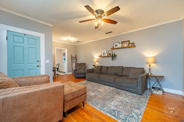 living room with ceiling fan, wood-type flooring, and ornamental molding