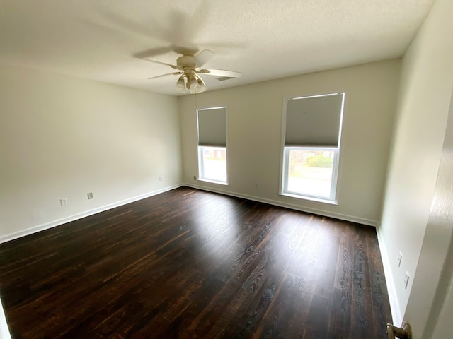 spare room with ceiling fan, dark hardwood / wood-style flooring, and a textured ceiling