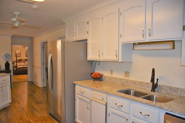3374 Lake Oak Ridge Dr, Enterprise, AL 36330 - kitchen featuring a sink, stainless steel fridge, white cabinetry, dark wood-type flooring, and a ceiling fan