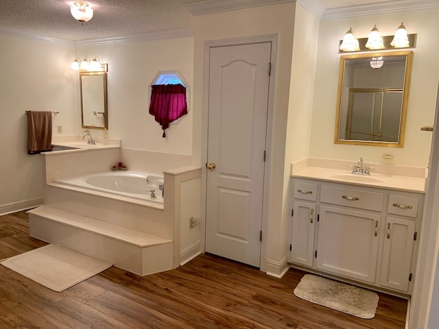 3374 Lake Oak Ridge Dr, Enterprise, AL 36330 - full bathroom featuring wood finished floors, ornamental molding, a bath, vanity, and a textured ceiling