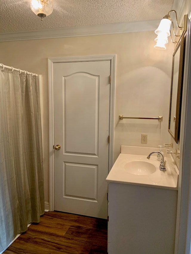3374 Lake Oak Ridge Dr, Enterprise, AL 36330 - full bath featuring a textured ceiling, wood finished floors, vanity, crown molding, and a shower with curtain