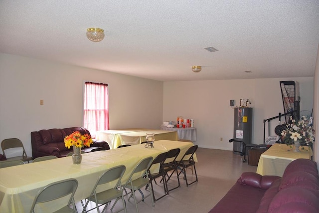 3374 Lake Oak Ridge Dr, Enterprise, AL 36330 - living area featuring electric water heater and a textured ceiling
