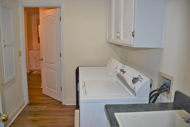 3374 Lake Oak Ridge Dr, Enterprise, AL 36330 - clothes washing area with dark wood-type flooring, washing machine and clothes dryer, cabinet space, and baseboards