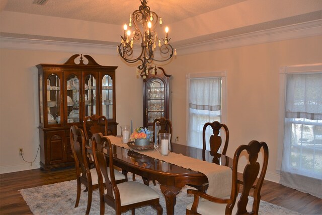 3374 Lake Oak Ridge Dr, Enterprise, AL 36330 - dining area with a chandelier, dark wood-style flooring, crown molding, and baseboards