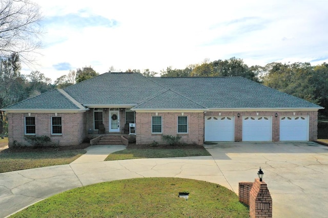 3374 Lake Oak Ridge Dr, Enterprise, AL 36330 - ranch-style house with curved driveway, brick siding, an attached garage, and a front lawn